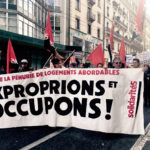 Des manifestants portent une banderole "Contre la pénurie de logements abordables, exproprions et occupons!"
