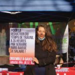 Une militante de solidaritéS Vaud tient une pancarte