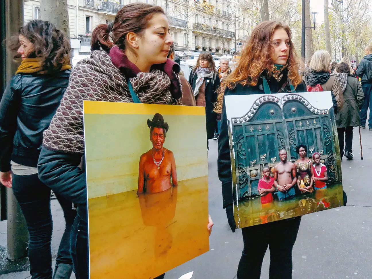 Des personnes tiennent des pancartes montrant les dégâts environnementaux dans les pays du Sud global
