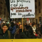 Manifestante avec une pancarte contre la spéculation immobilière